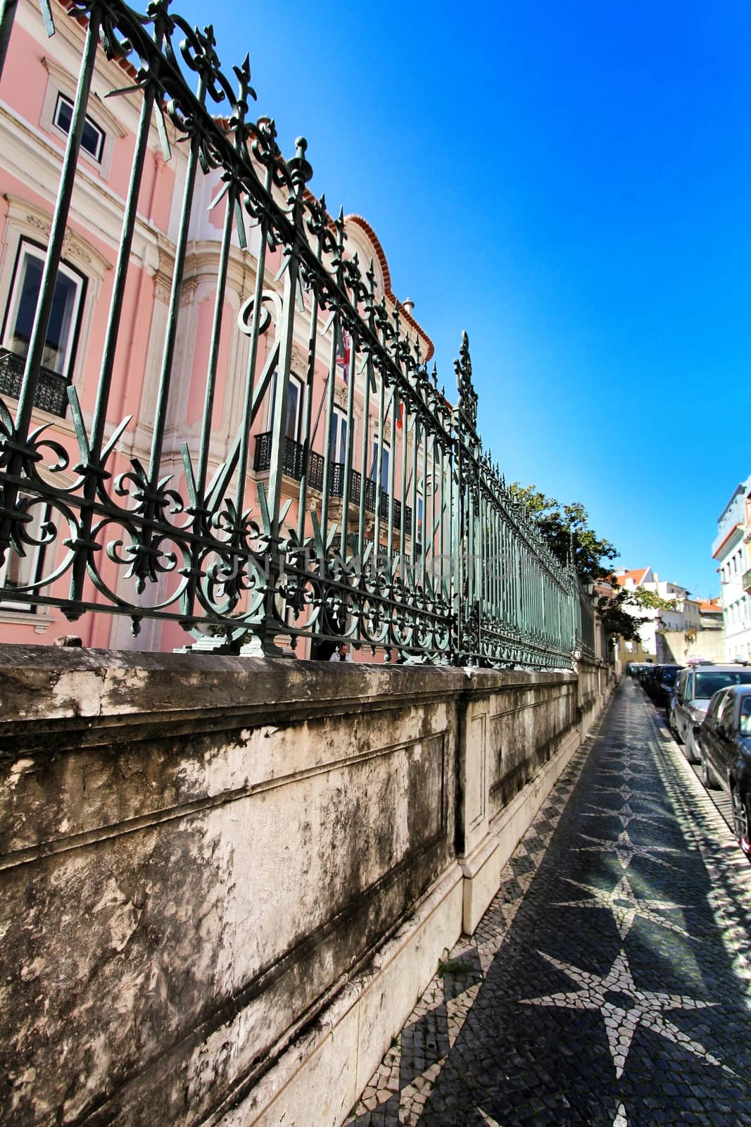 Colorful streets with majestic facades, windows and balconies of Lisbon city in Portugal on a sunny day