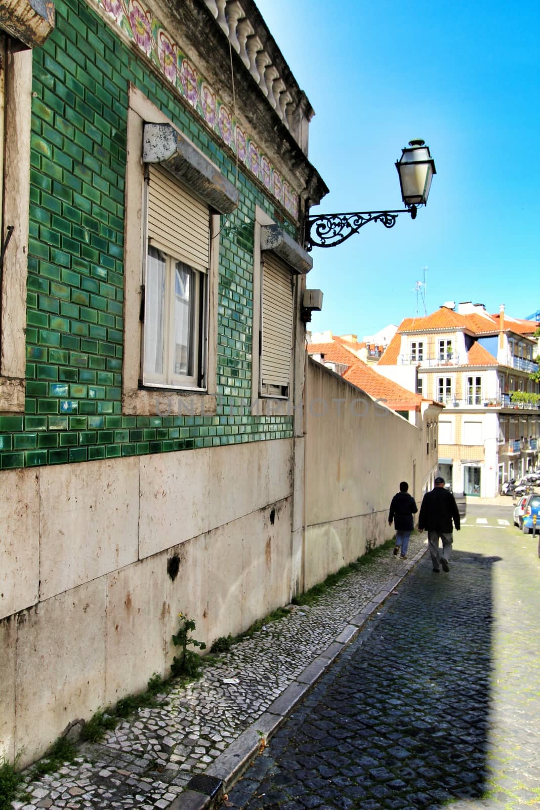 Colorful streets with majestic facades, windows and balconies of Lisbon city in Portugal on a sunny day