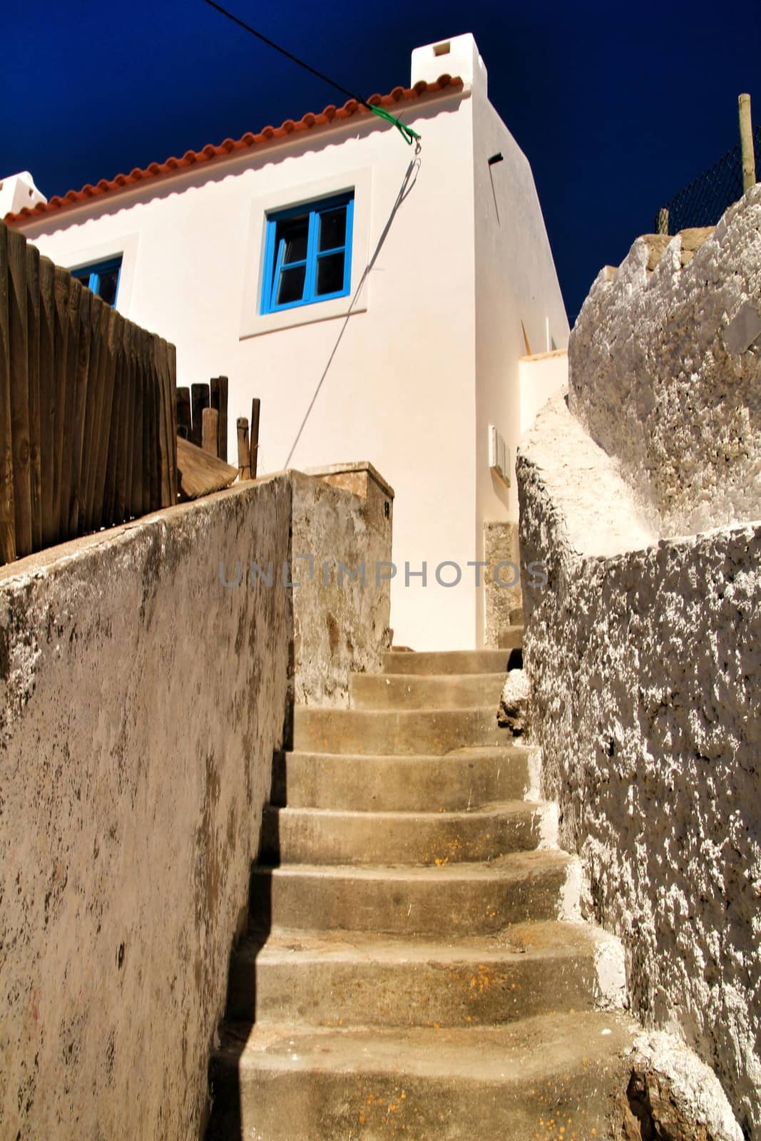 Beautiful narrow streets, white houses and roofs of Azenhas do Mar village in Lisbon, Portugal