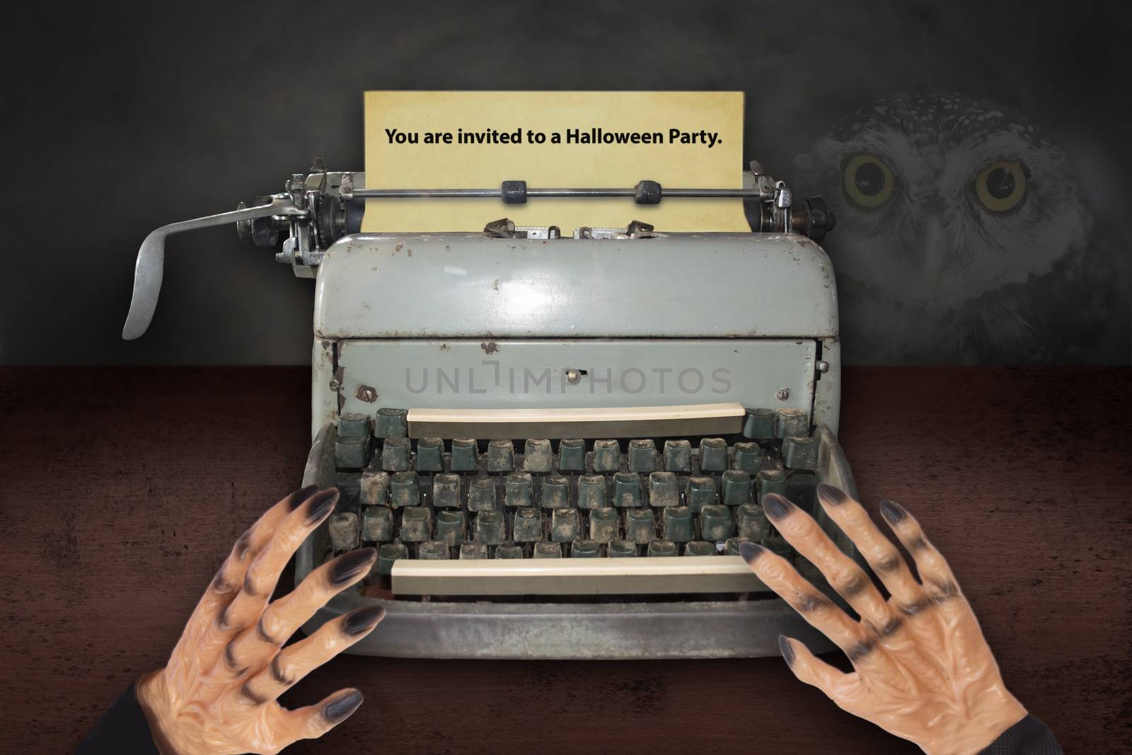 Devil's hand typing invitations for Halloween with old typewrite by pandpstock_002