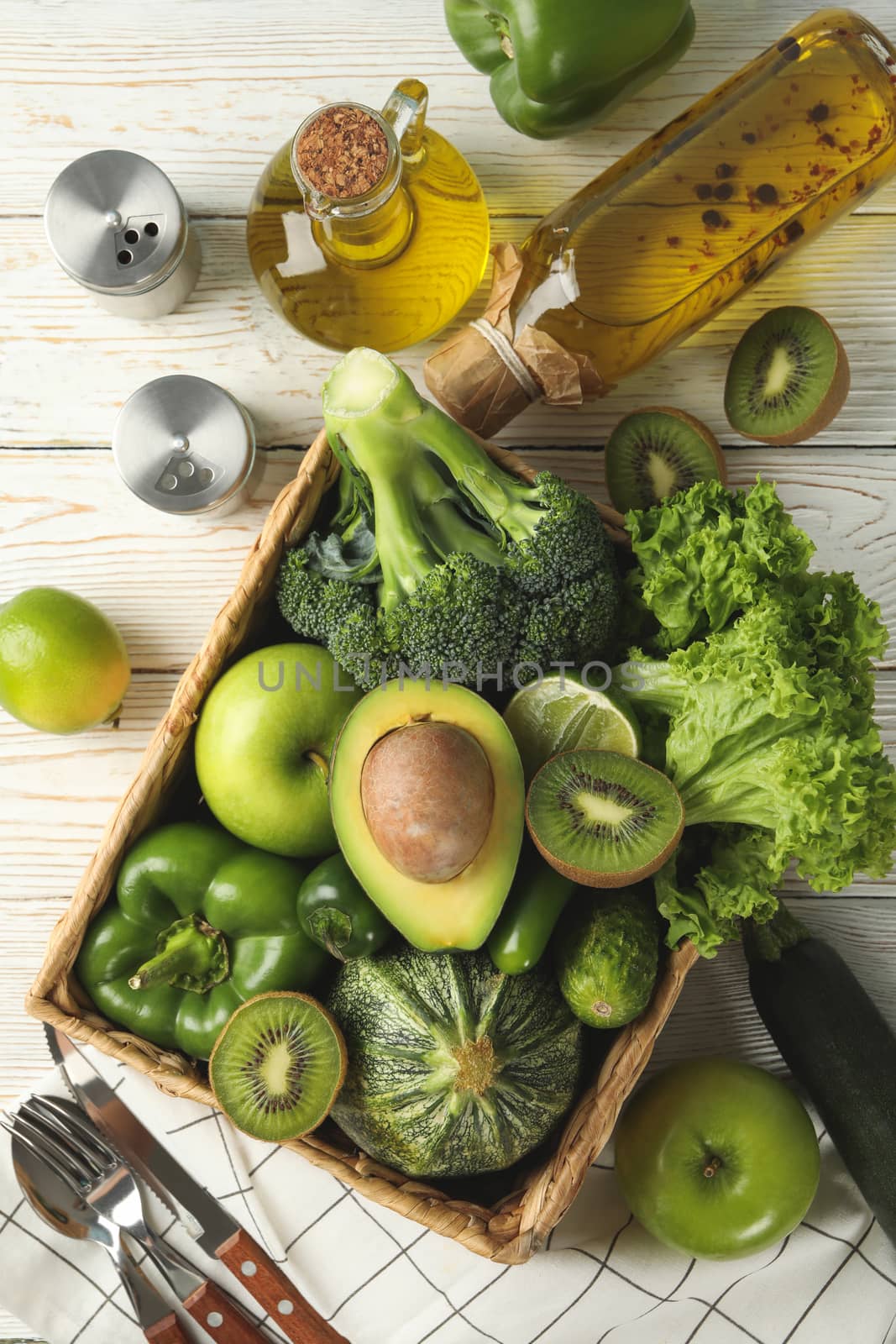 Concept of healthy food with vegetables and fruits on white wooden table