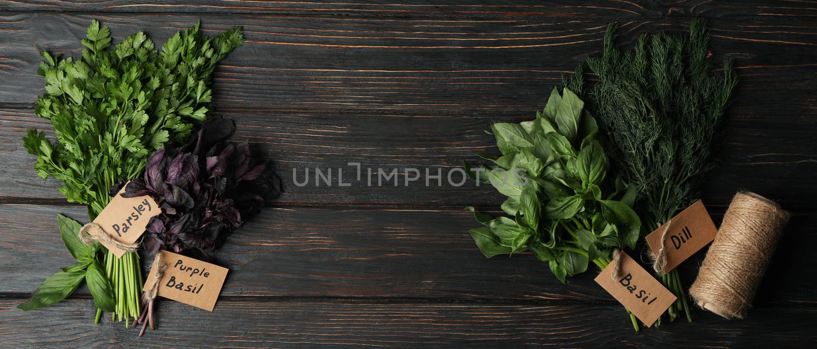 Different herbs on wooden background, top view