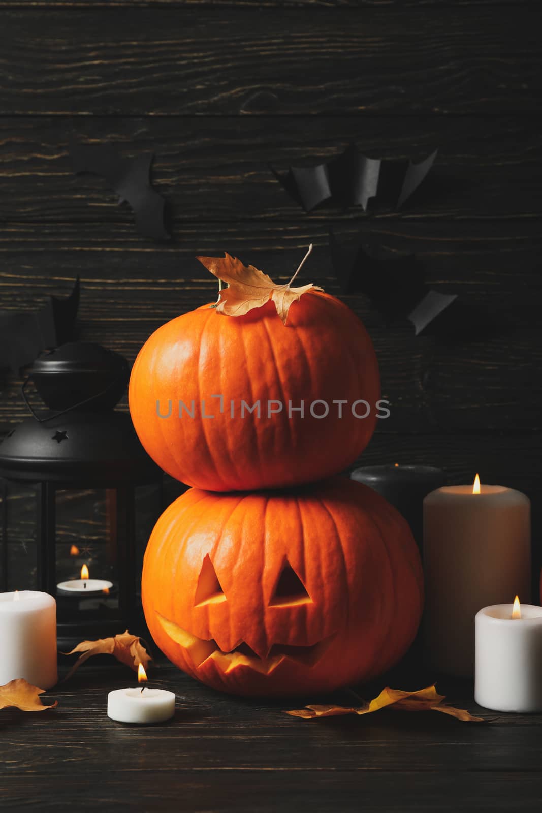 Pumpkins and halloween accessories on wooden background