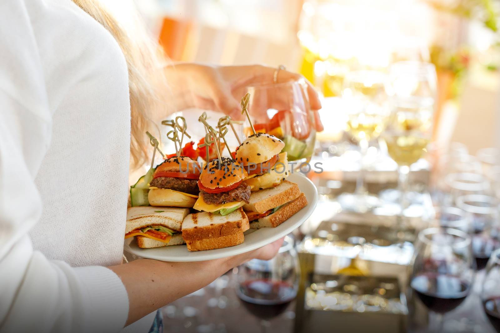 Guest holding a plate of different snacks at the event