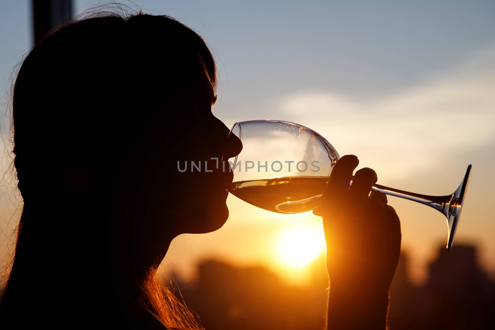 Girl with wine glass. Black silhouette