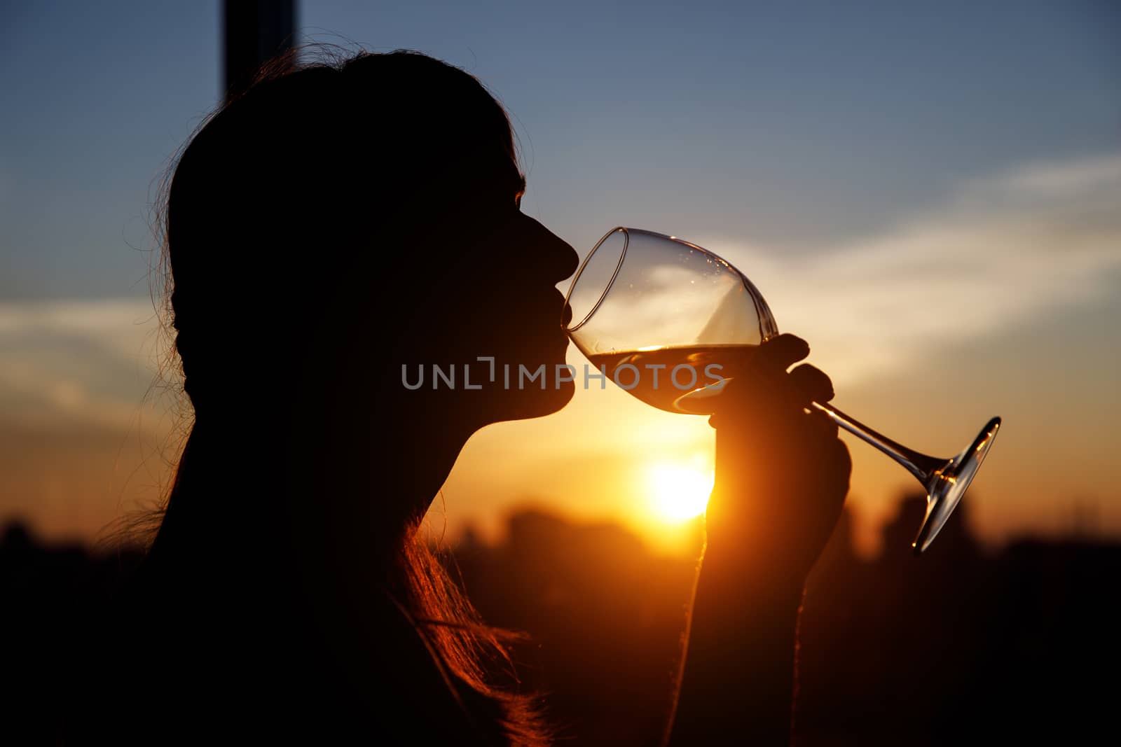 Girl with wine glass. Black silhouette