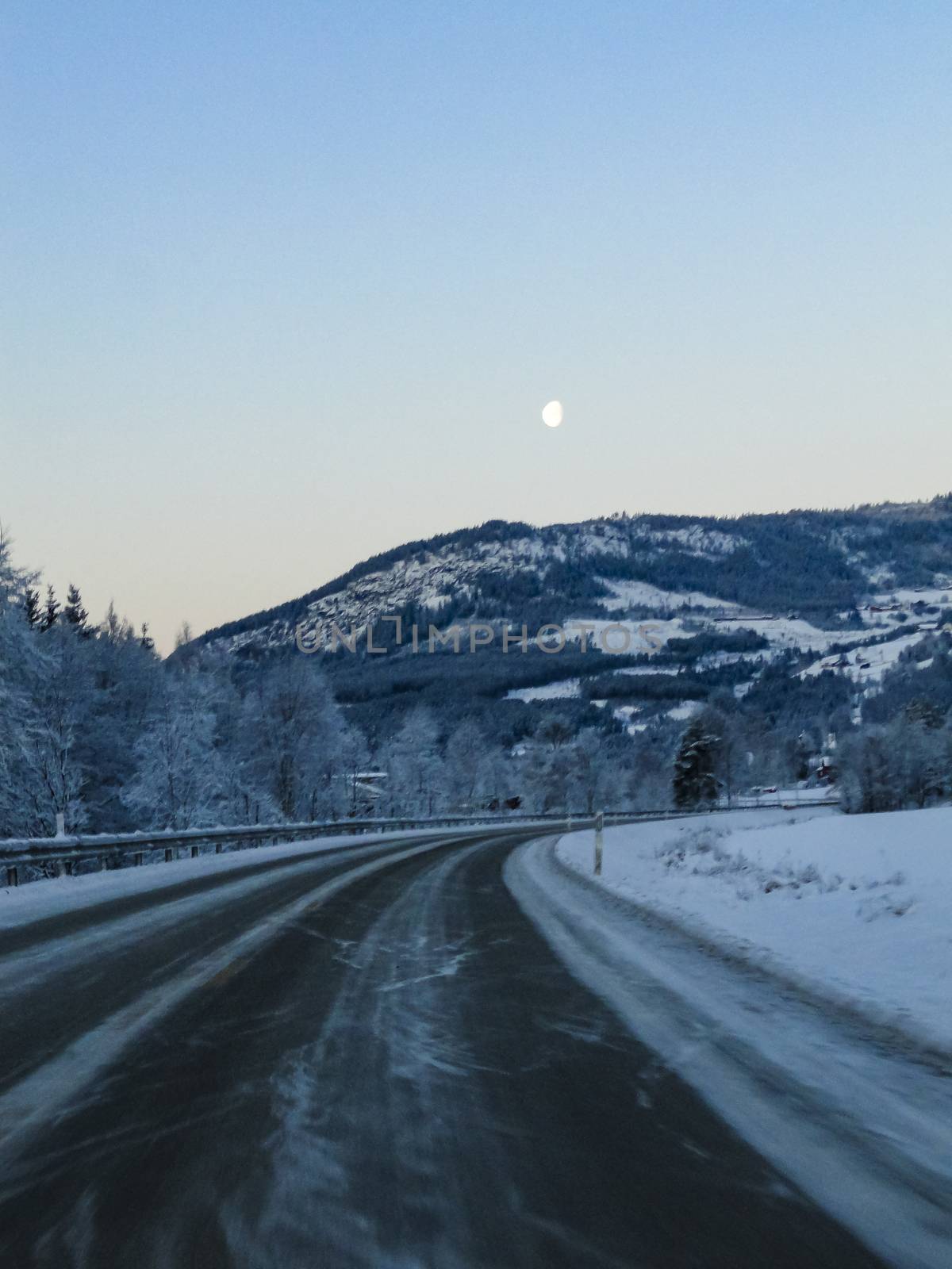 Driving fast at night through mountains and forests in Norway.