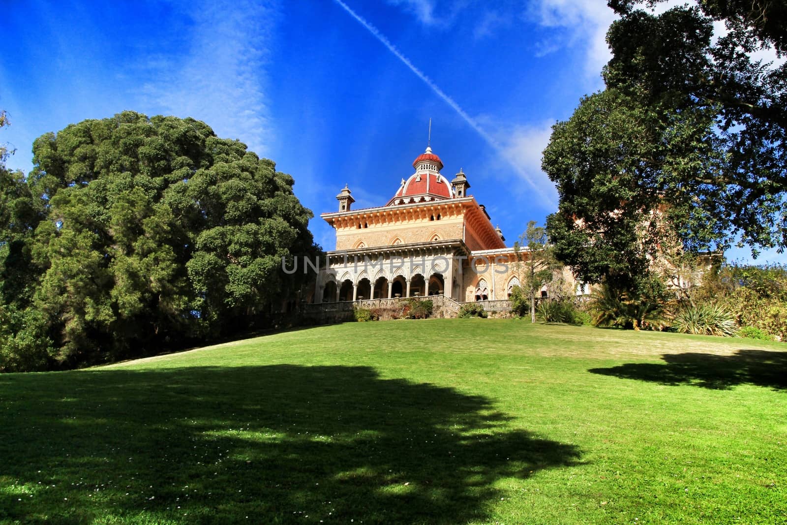 Monserrate palace between Leafy and green garden with large trees in Sintra, Lisbon