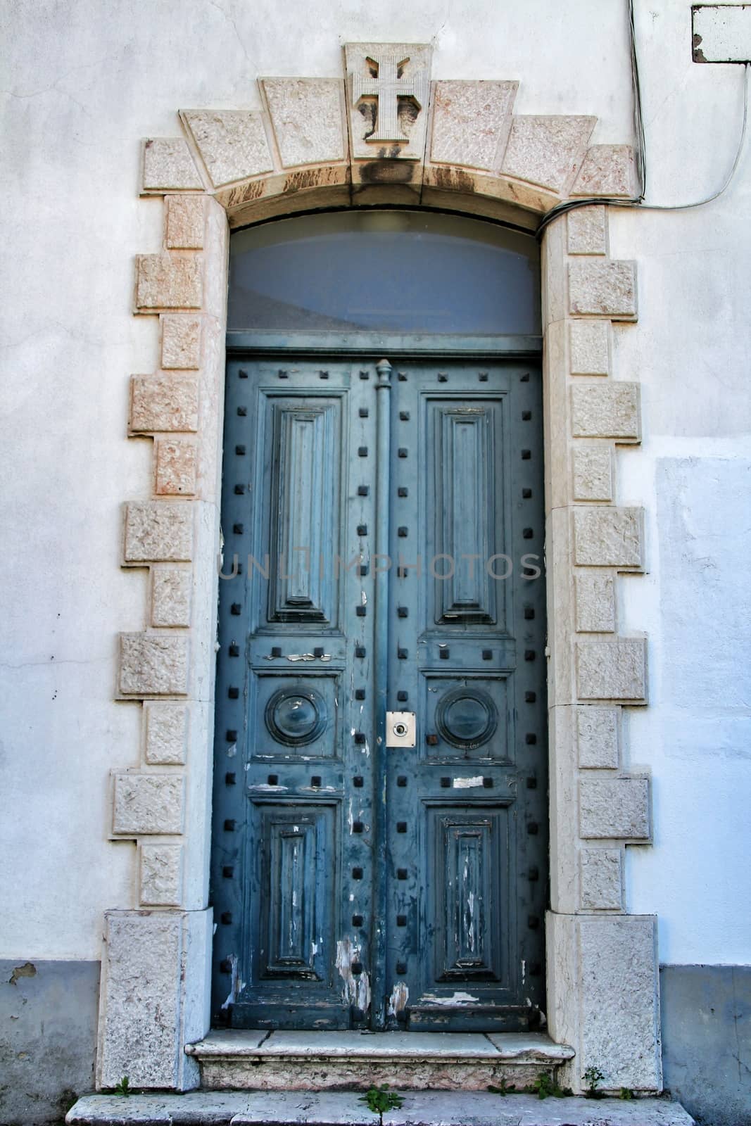 Old and colorful green wooden door with iron details in Lisbon, Portugal