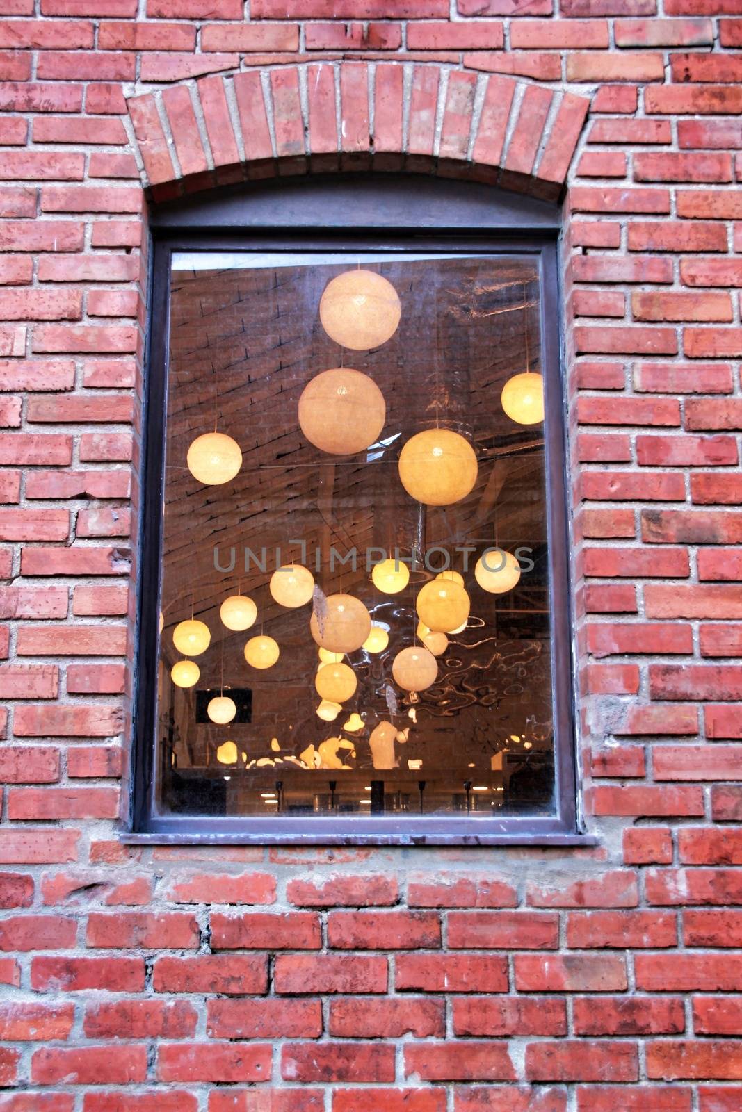 Round white lamps seen through a window. 