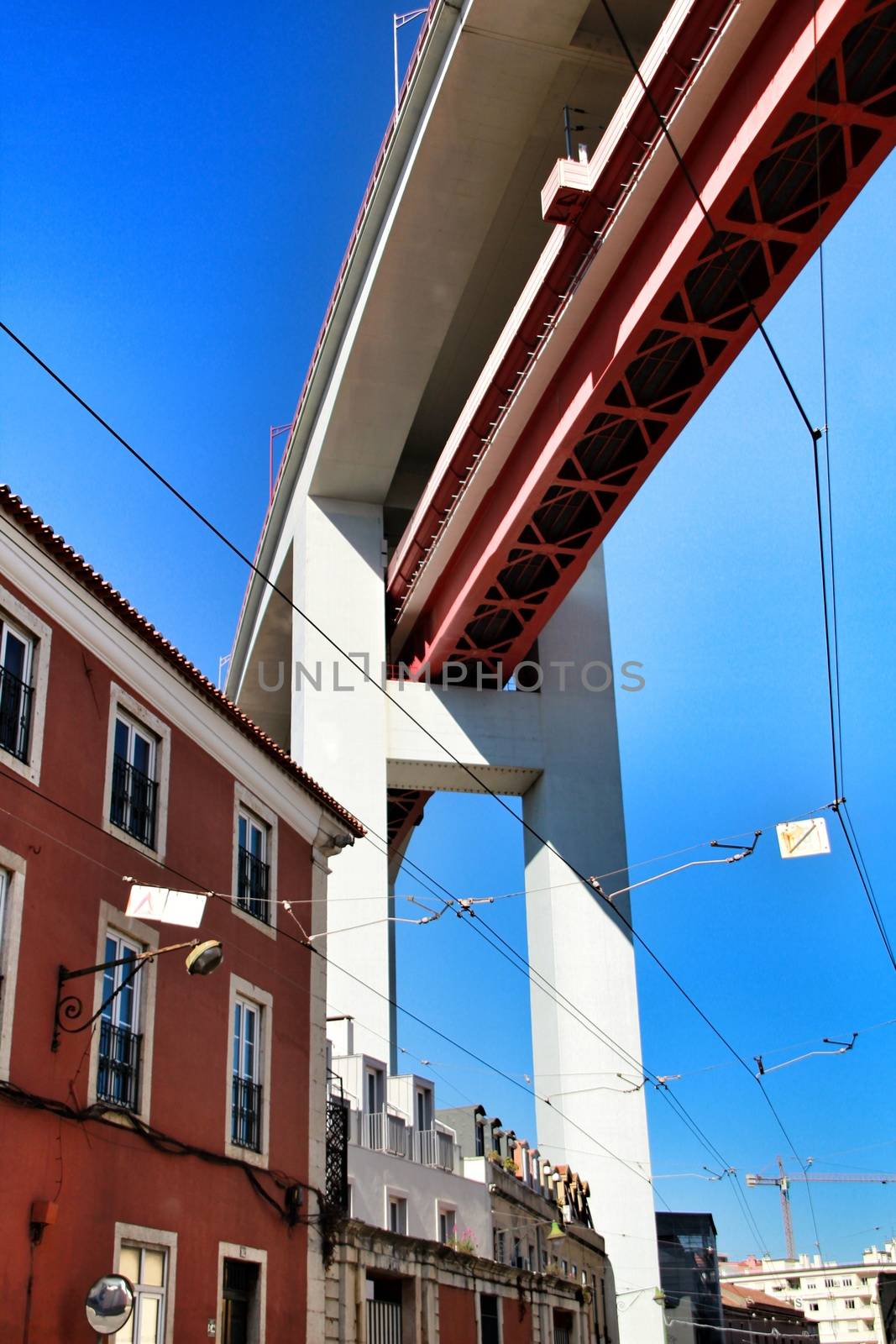 Beautiful 25th April bridge structure over street in Lisbon in a sunny day of Spring