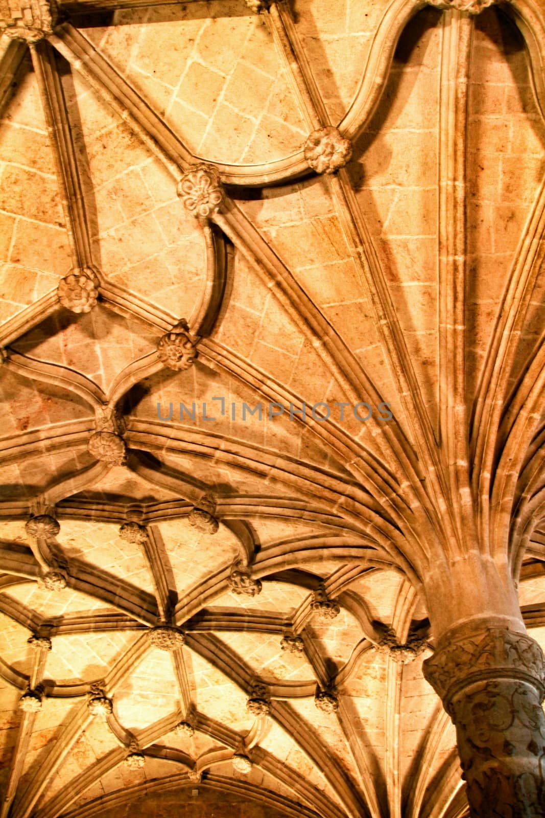 Arches and monumental columns with carved stone details of Santa Maria de Belem in Lisbon, Portugal