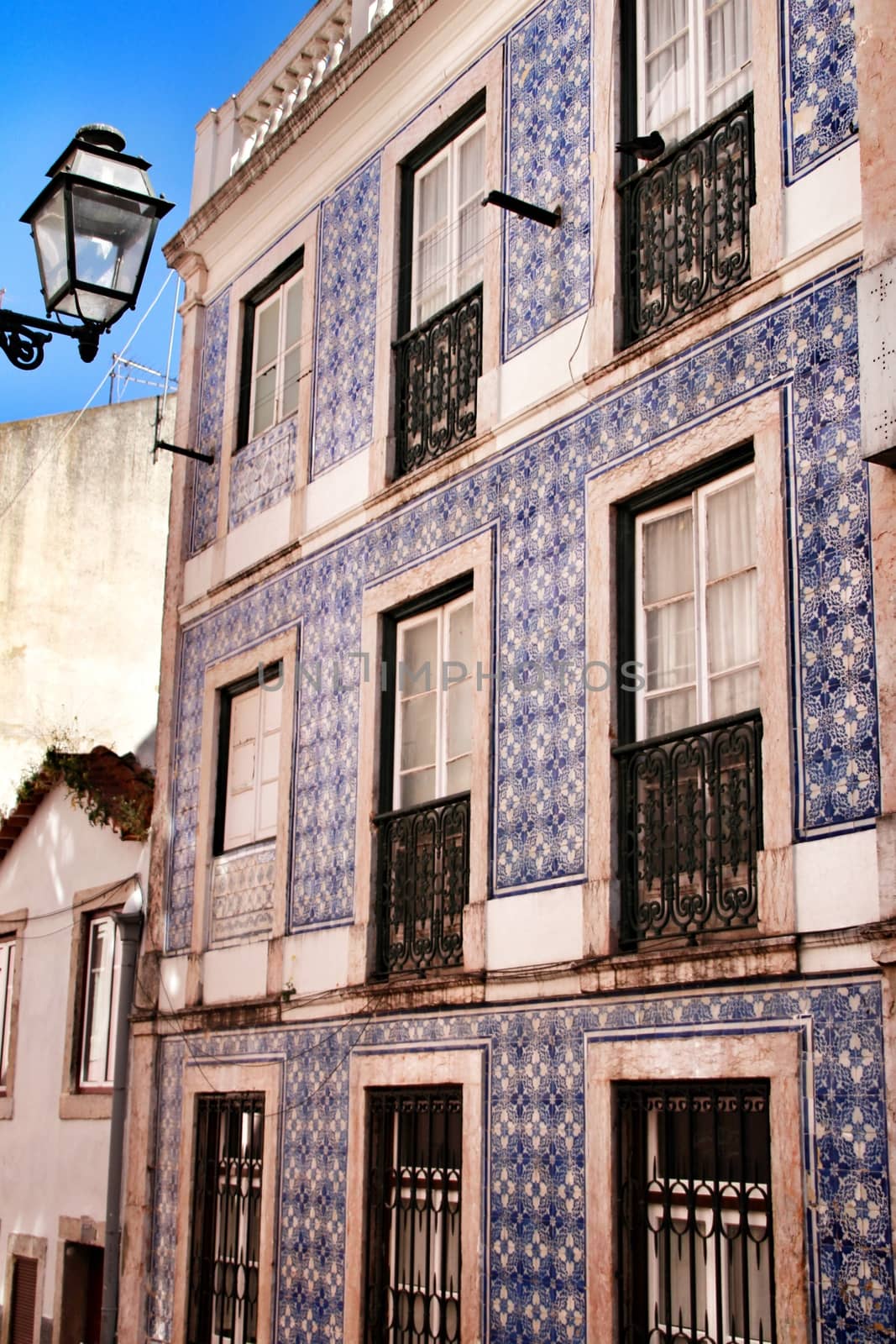 Narrow and colorful streets, majestic facades, windows and balconies of Lisbon, Portugal