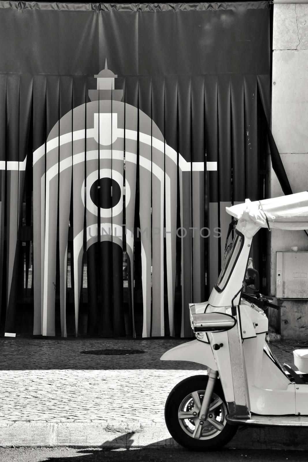 Tuk Tuk parked at the entrance of the Ribeira market in Lisbon. Monochrome picture.