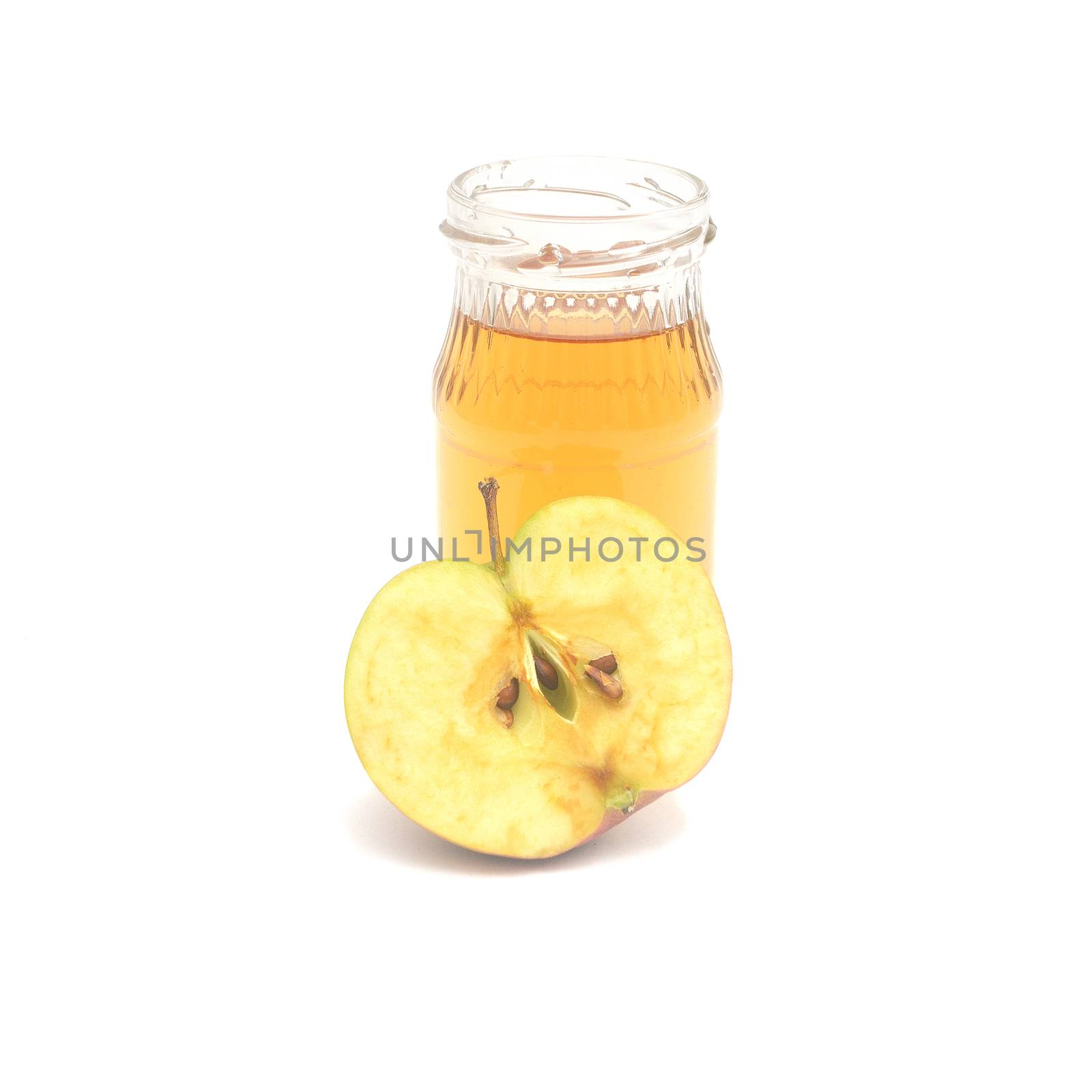 One half apple and a small bottle of apple cider vinegar isolated on white background. by andre_dechapelle