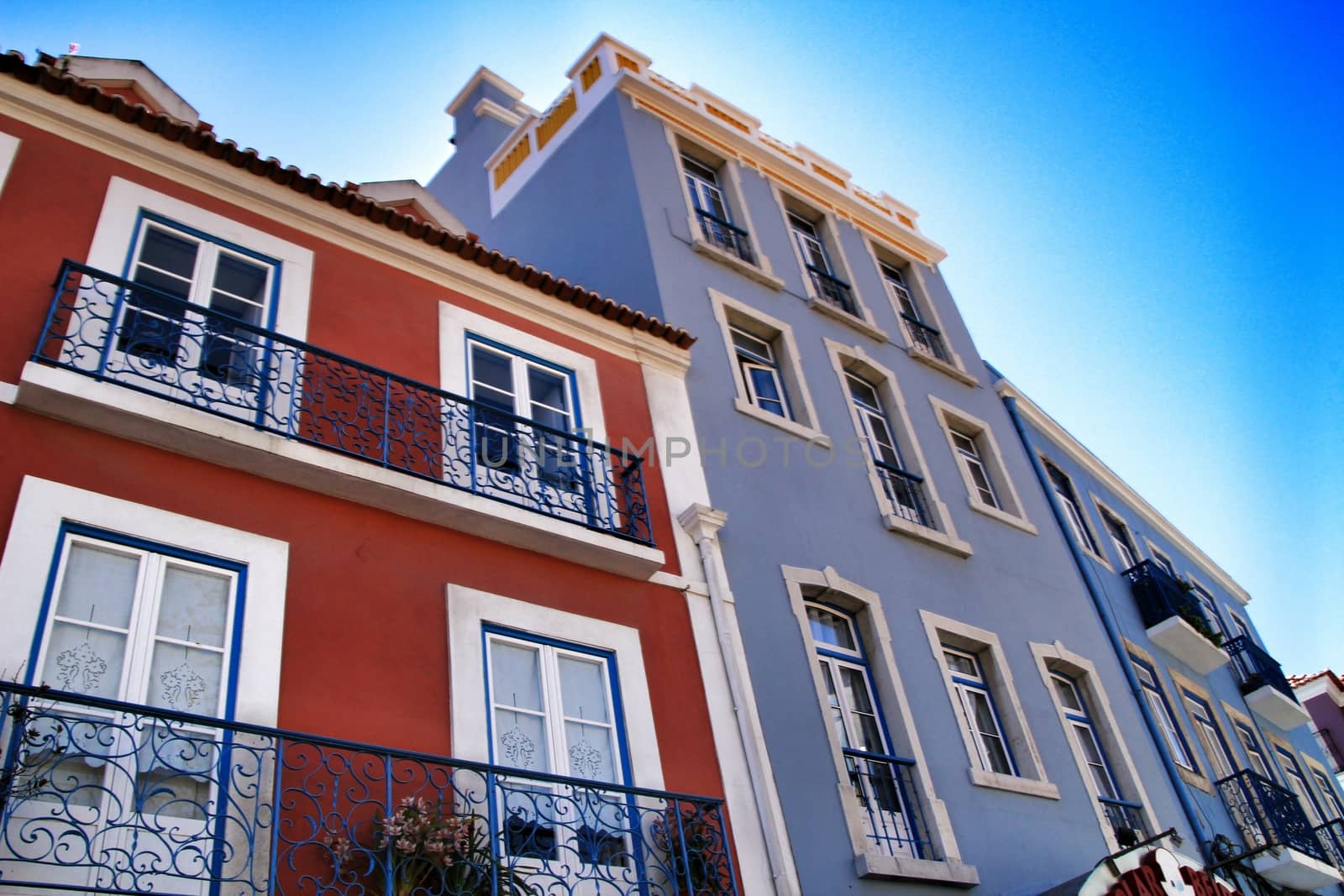 Old colorful houses and streets of Lisbon, Portugal in Spring. Majestic facades and old street lights.