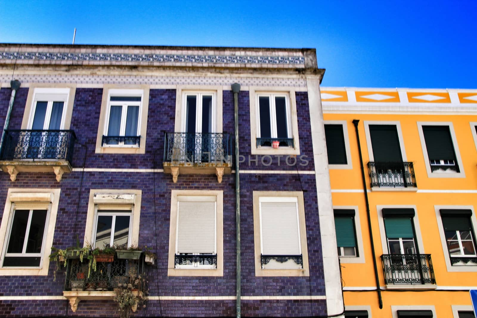 Old colorful houses and streets of Lisbon, Portugal in Spring. Majestic facades and old street lights.