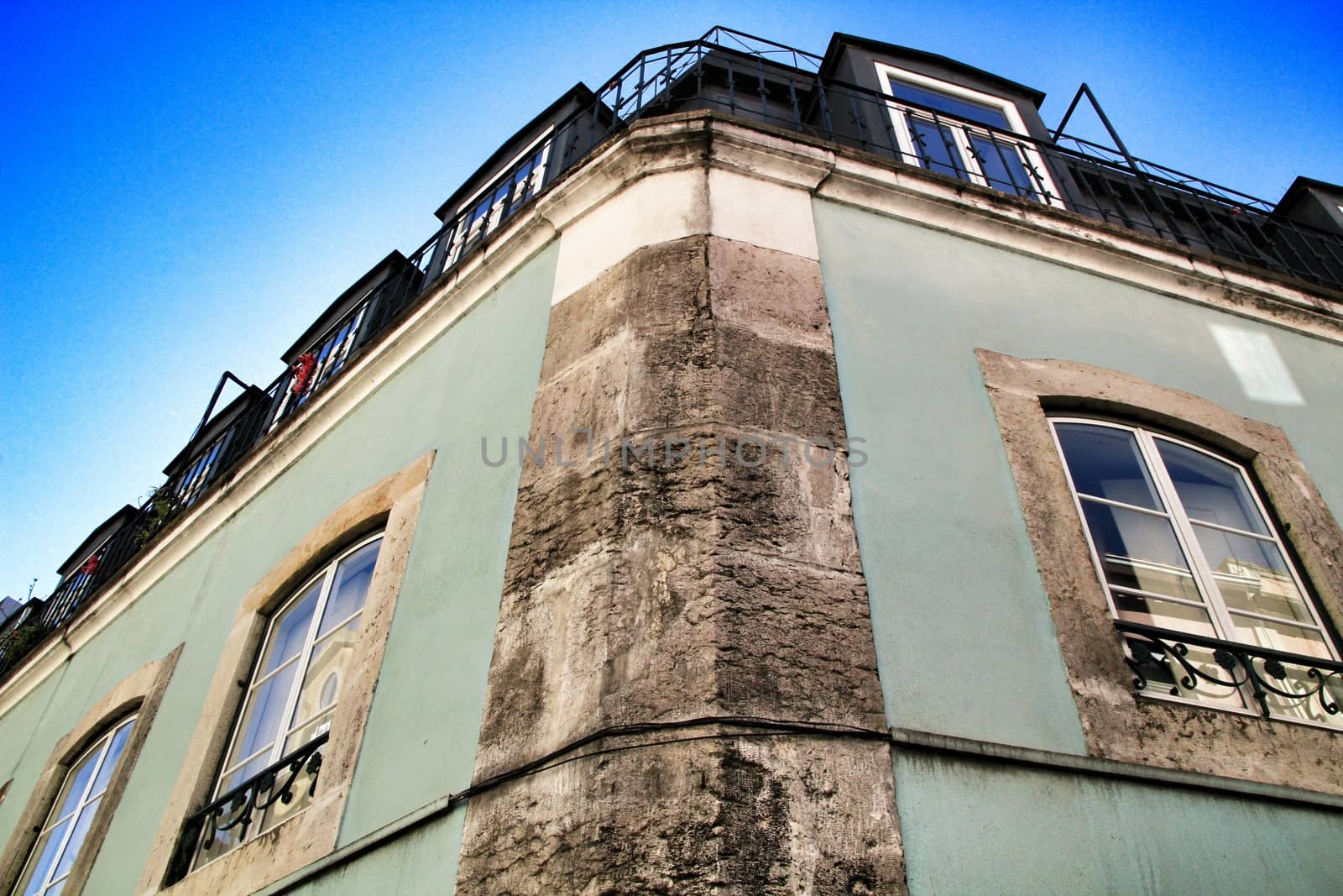 Old colorful houses and streets of Lisbon, Portugal in Spring. Majestic facades and old street lights.