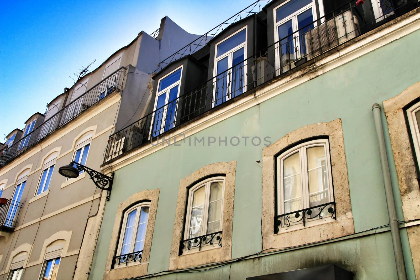 Old colorful houses and streets of Lisbon, Portugal in Spring. Majestic facades and old street lights.