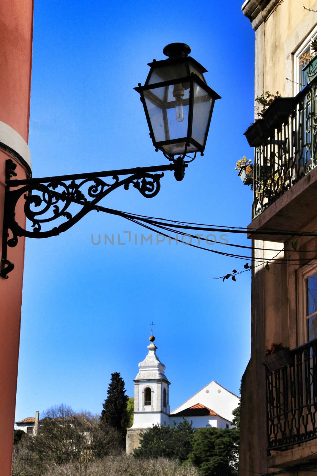 Old colorful and beautiful facades with vintage streetlight in Lisbon streets in Spring. 
