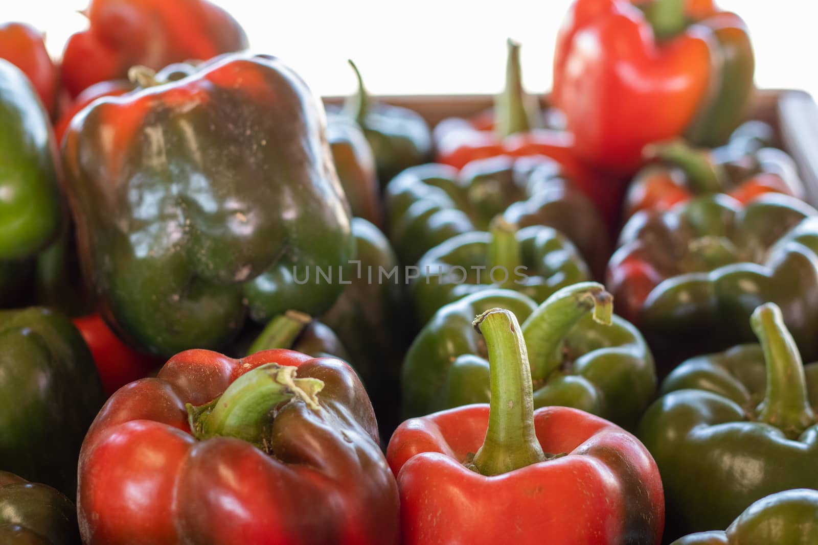 Close up of a Stack of Red and Green Bell Peppers by gena_wells
