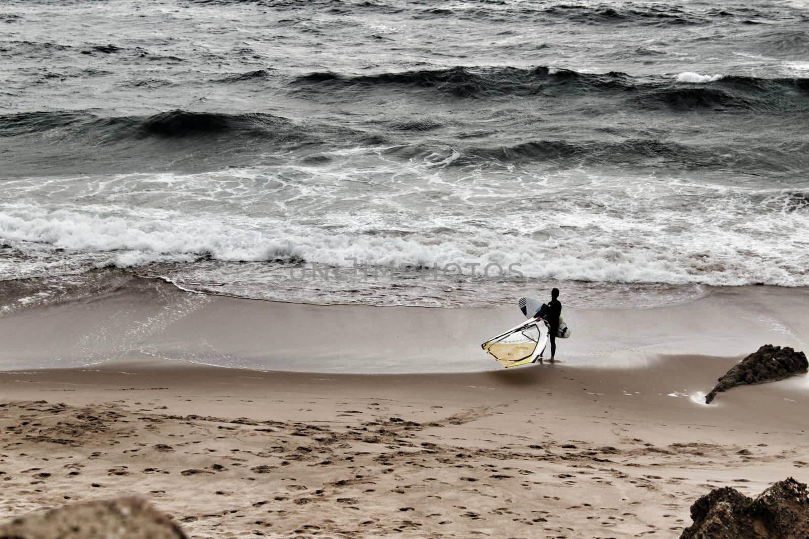 Surfers at Guincho beach under cloudy sky in spring Portugal