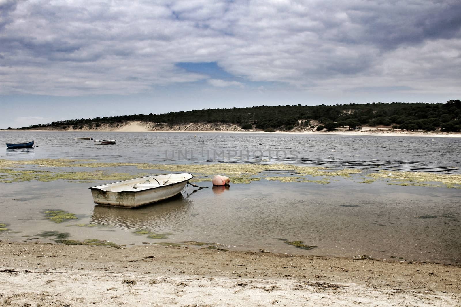 Boats on Lagoa de Albufeira on a cloudy day in Spring