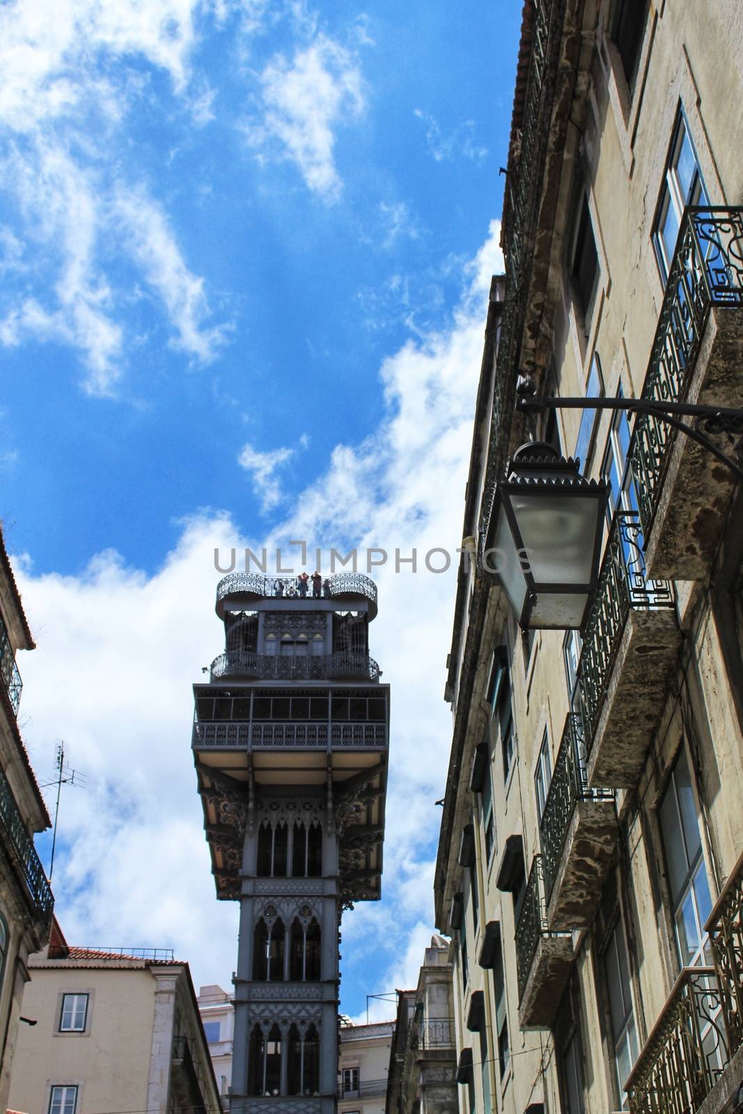 Lisbon, Portugal- May 30, 2018: Santa Justa Lift in Lisbon and majestic building facades under blue sky, Portugal.