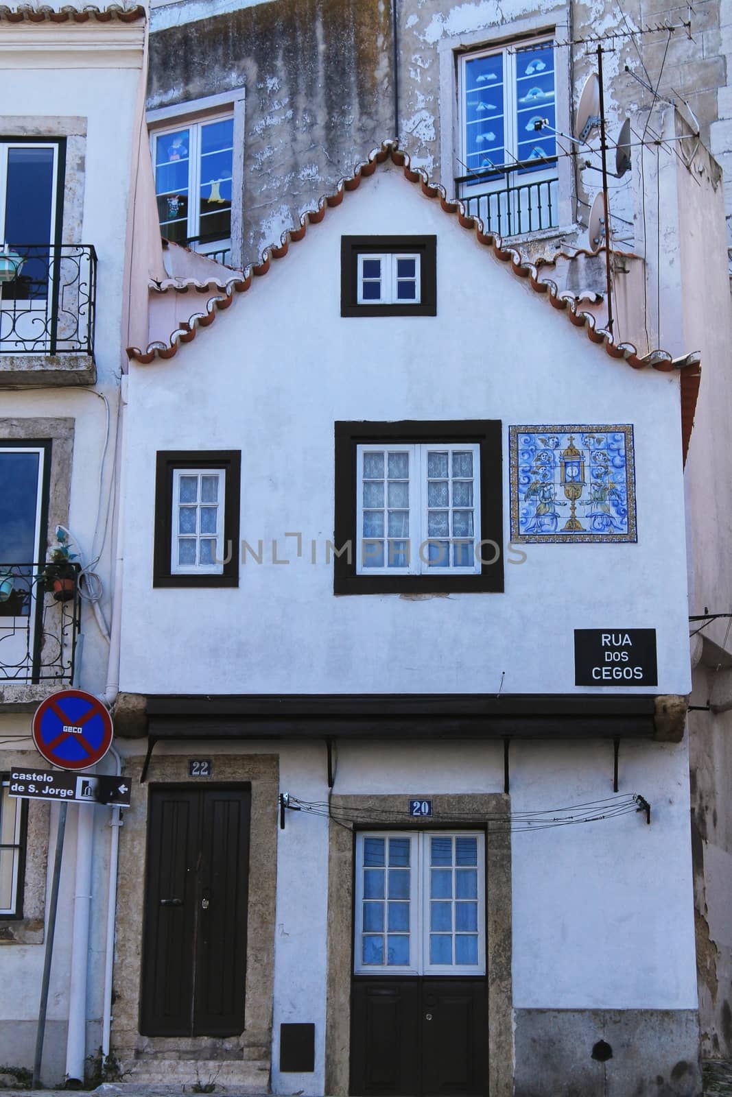 Old colorful houses and streets of Lisbon, Portugal in Spring. Majestic facades and old street lights.