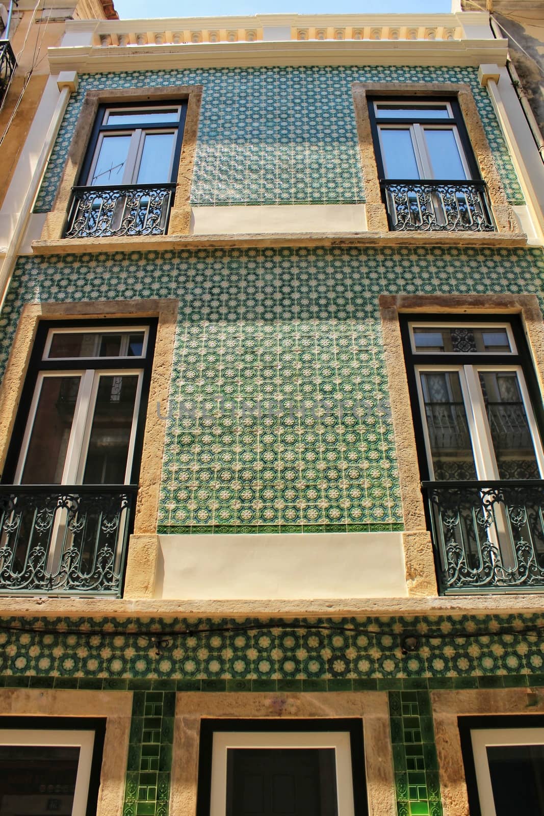 Old colorful houses and streets of Lisbon, Portugal in Spring. Majestic facades and old street lights.