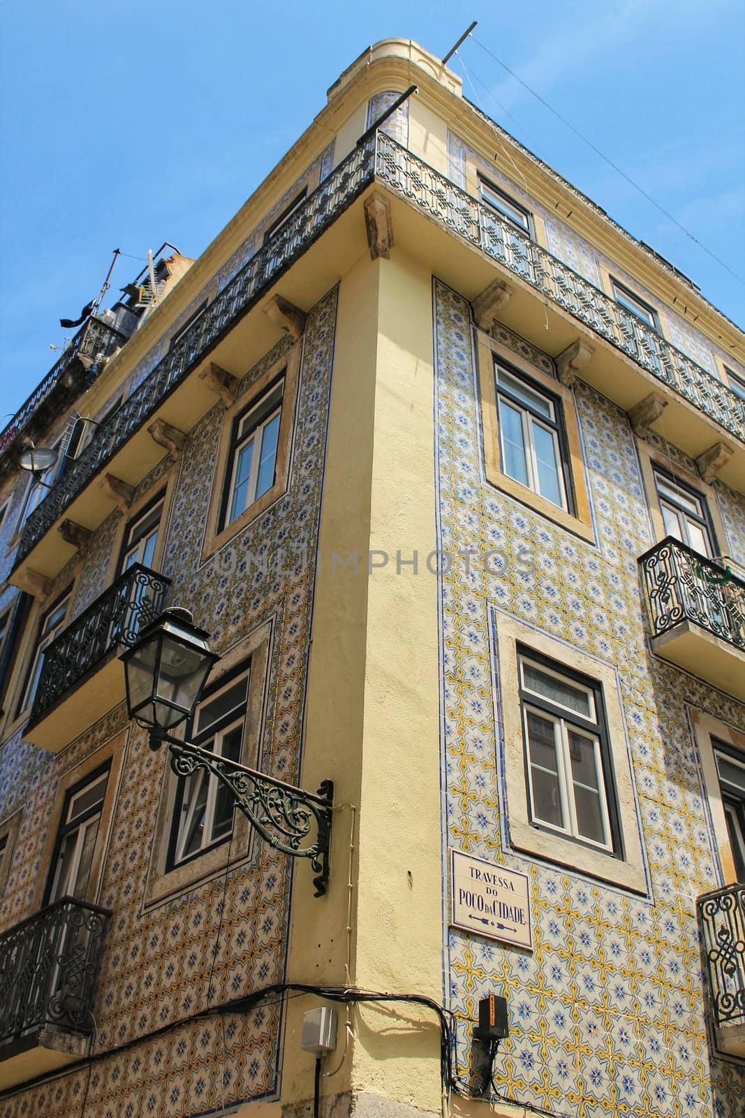Old colorful houses and streets of Lisbon, Portugal in Spring. Majestic facades and old street lights.