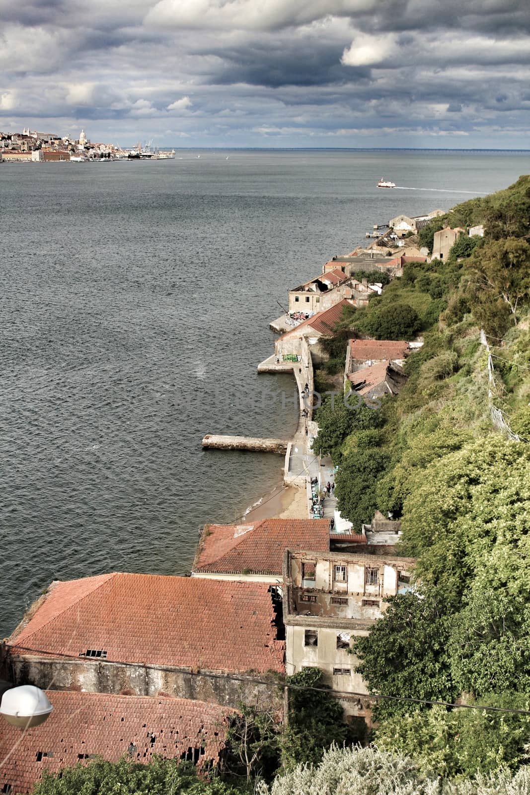 Panoramic of the docks of Cacilhas village and Tagus river on a cloudy day