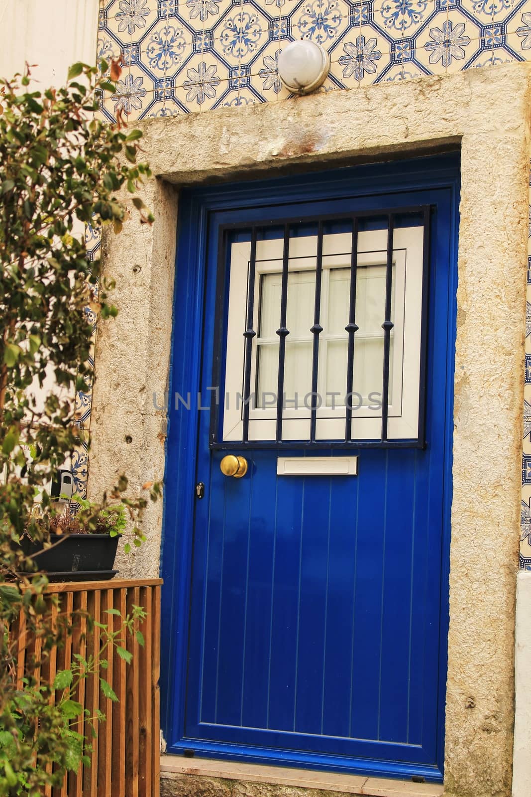 Old and colorful wooden door with iron details in Lisbon, Portugal