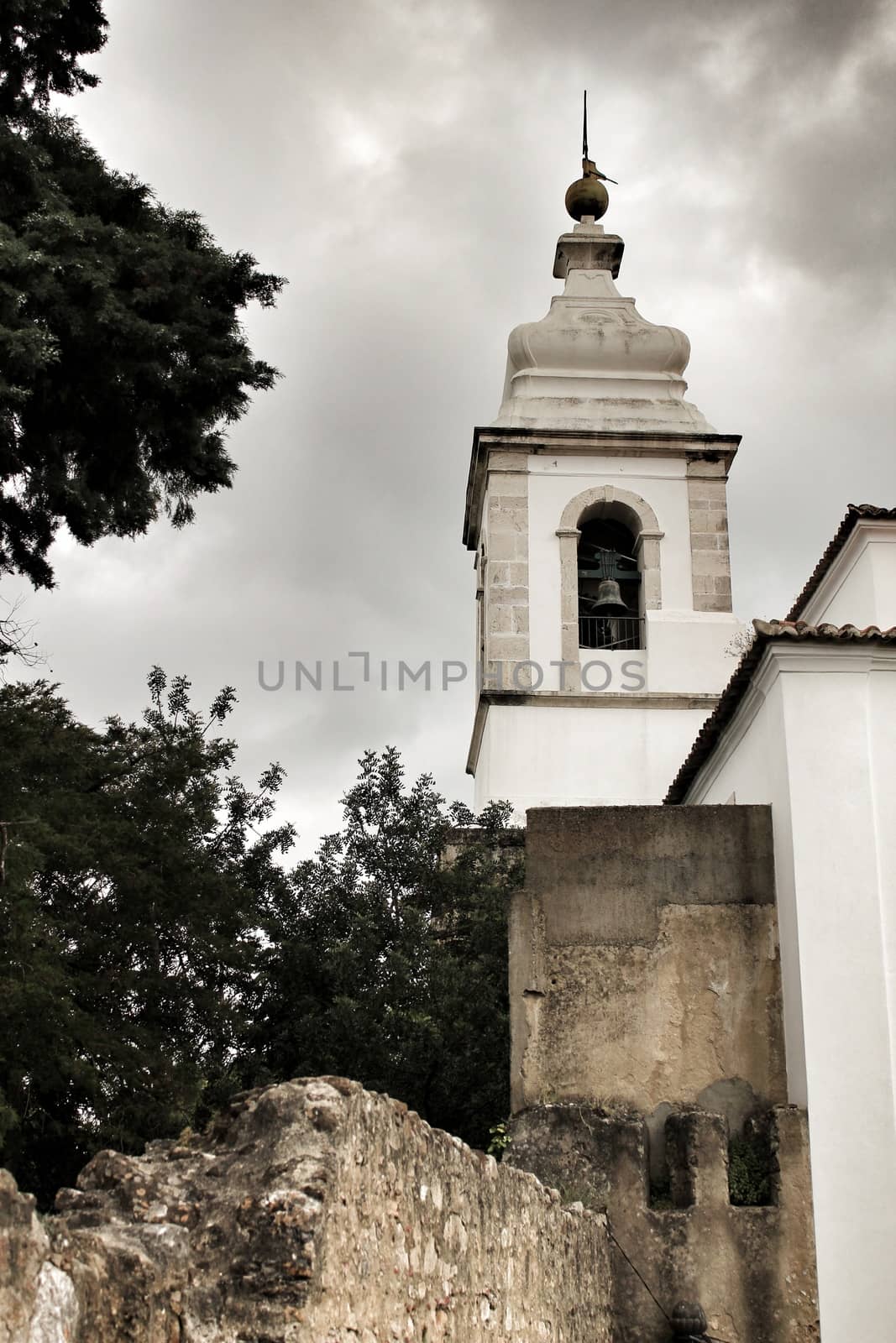 Old and majestic antique church in Lisbon, Portugal, under cloudy sky