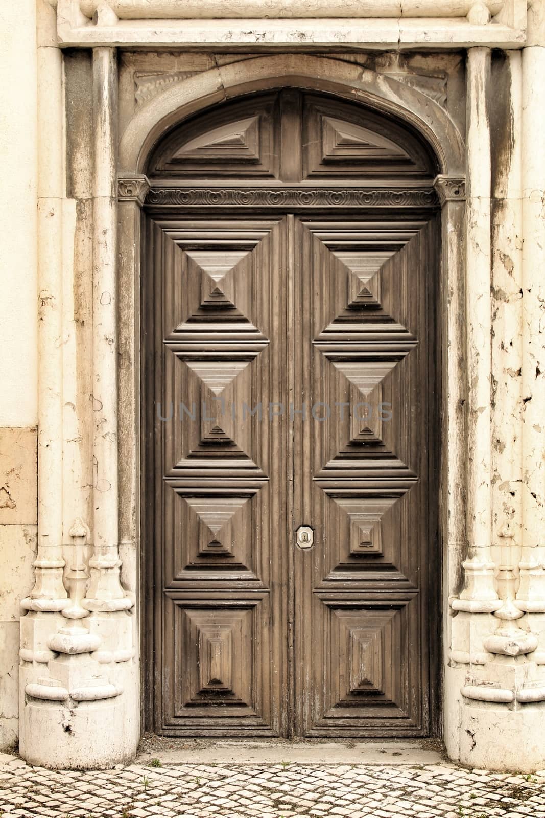 Old wooden door with wrought iron details in Lisbon