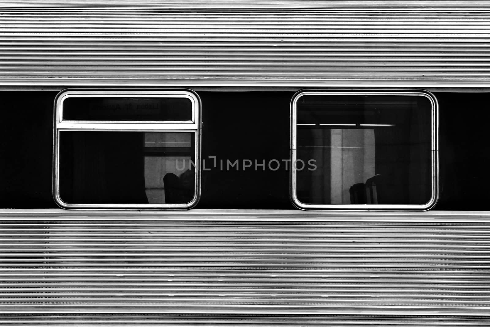 Train carriage windows. Metallic texture monochrome photography.