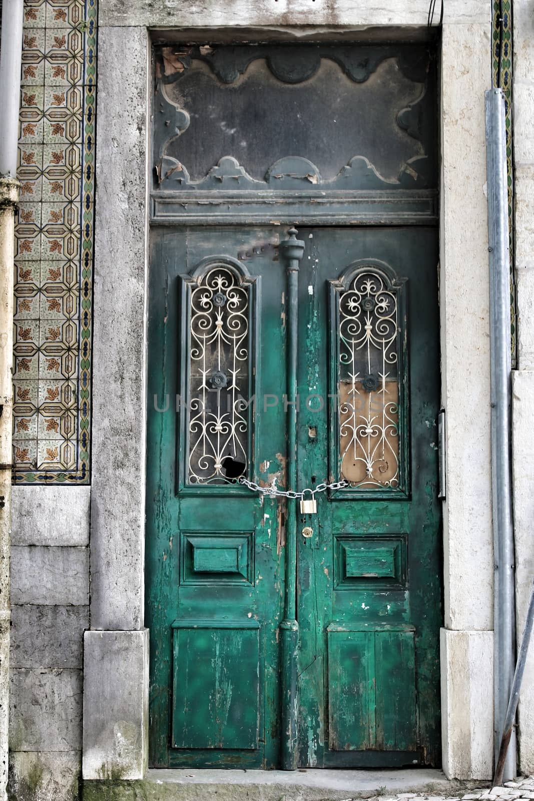 Old and colorful wooden door with iron details in Lisbon, Portugal