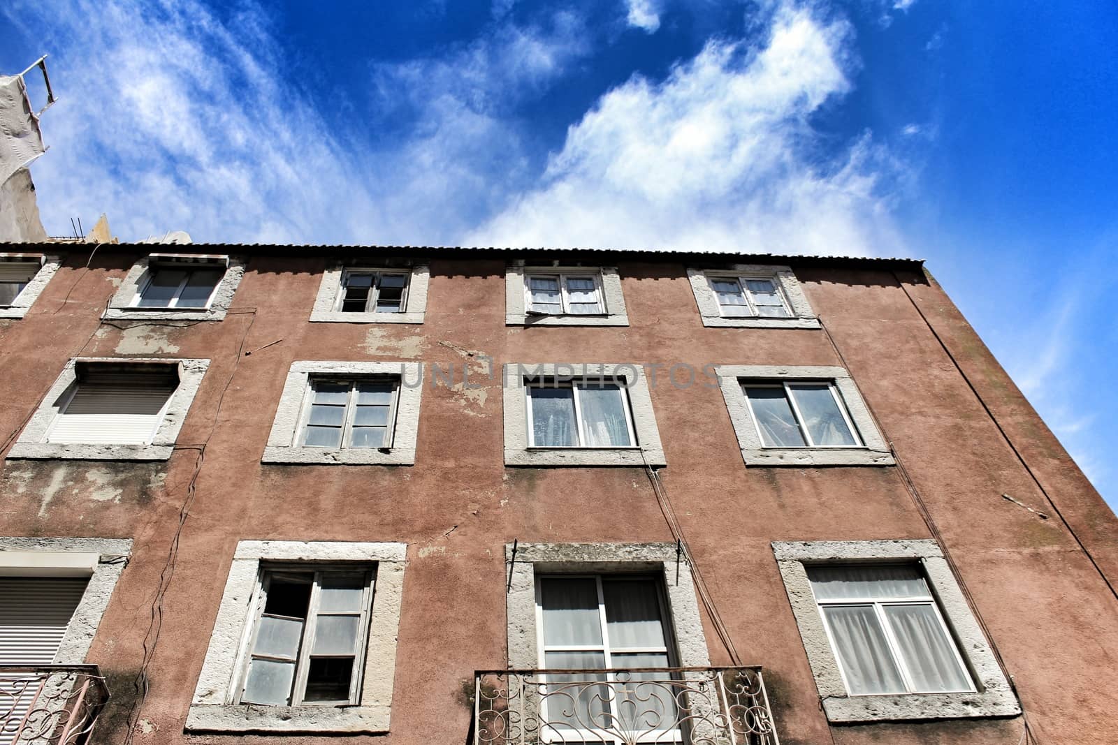 Old colorful houses and narrow streets of Lisbon, Portugal in Spring. Majestic facades and old street lights.