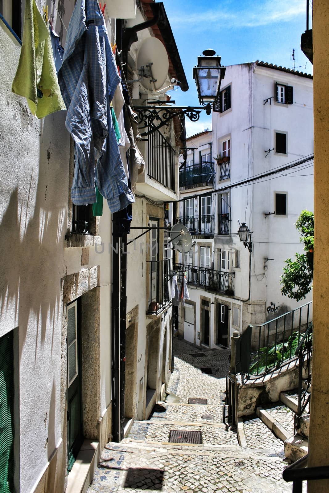 Old colorful houses and narrow streets of Lisbon by soniabonet
