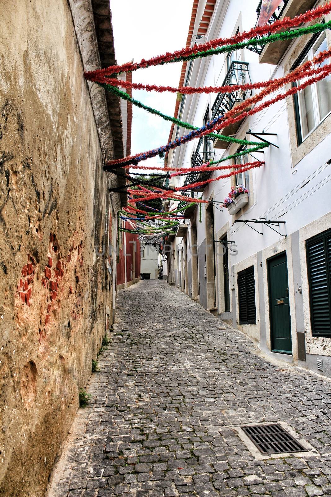 Streets adorned with garlands in Alfama, Lisbon by soniabonet