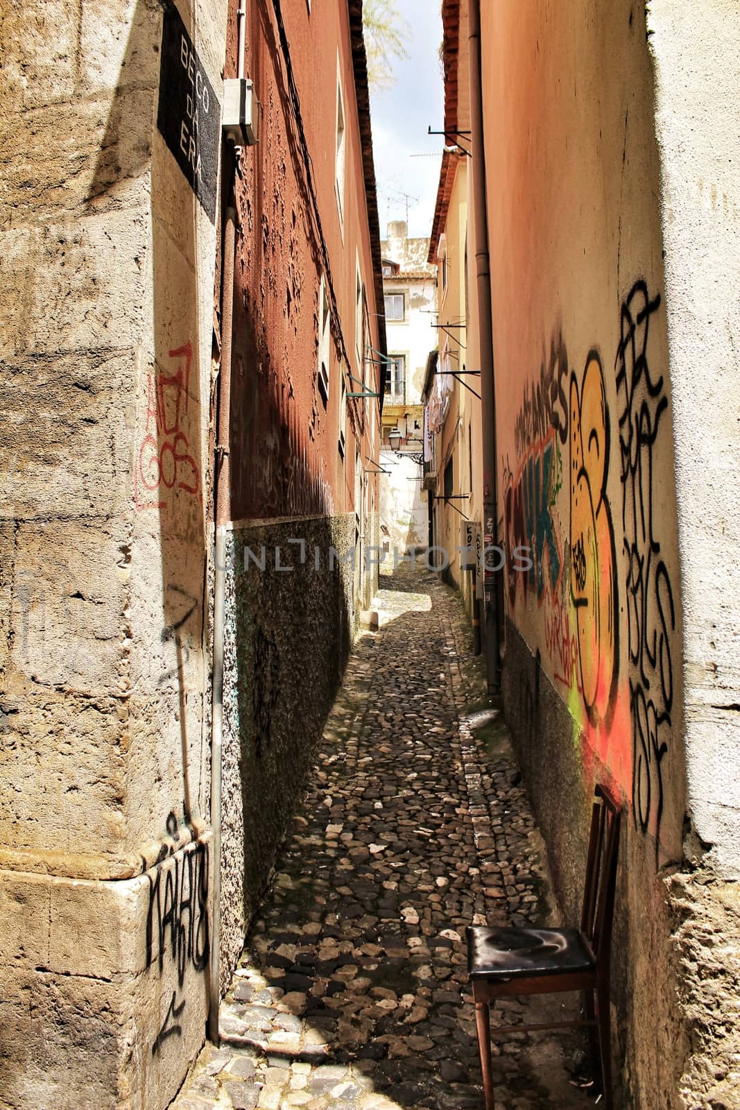 Lisbon, Portugal- June 10, 2018: Old colorful houses and narrow streets of Lisbon, Portugal in Spring. Majestic facades and old street lights.