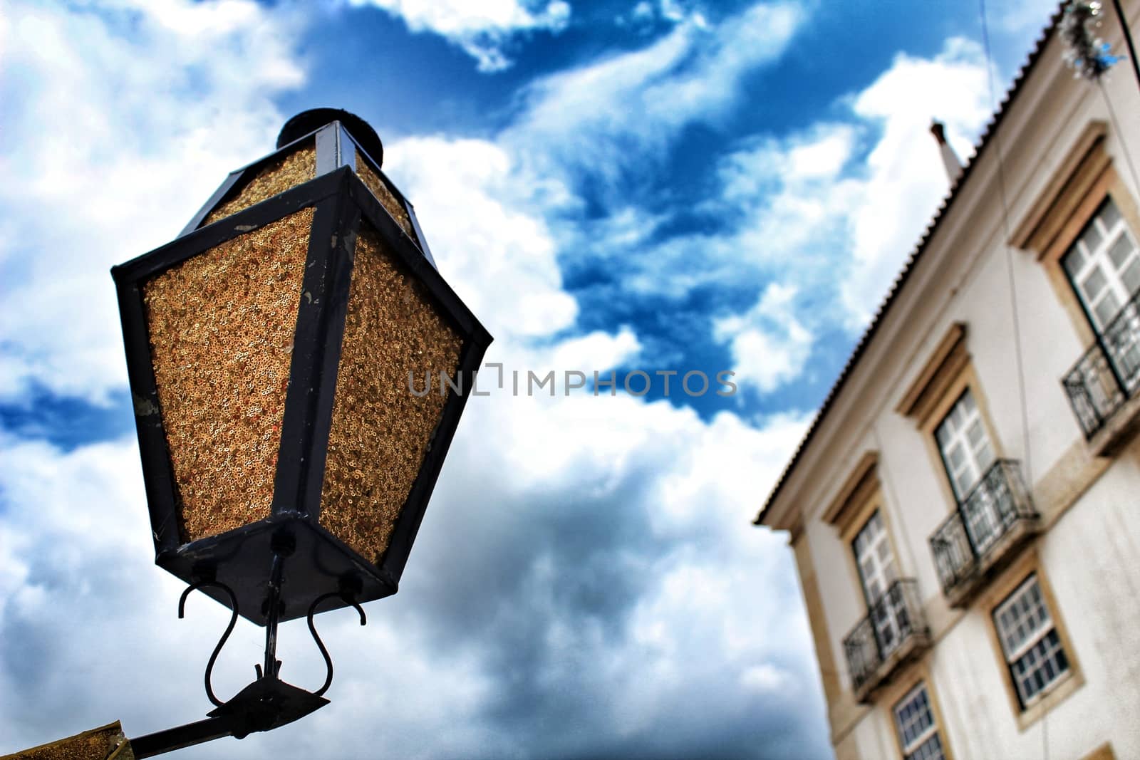 Old colorful houses and streets of Lisbon, Portugal in Spring. Majestic facades and old street lights.