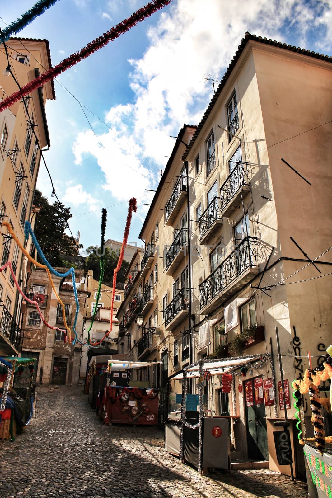 Old colorful houses and streets of Lisbon, Portugal in Spring. Majestic facades and old street lights.