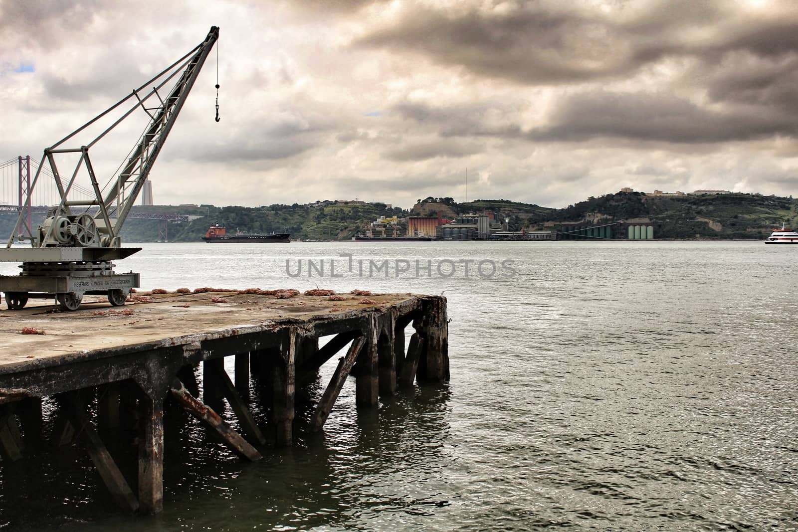Old crane and dock on the shore of The Tagus River