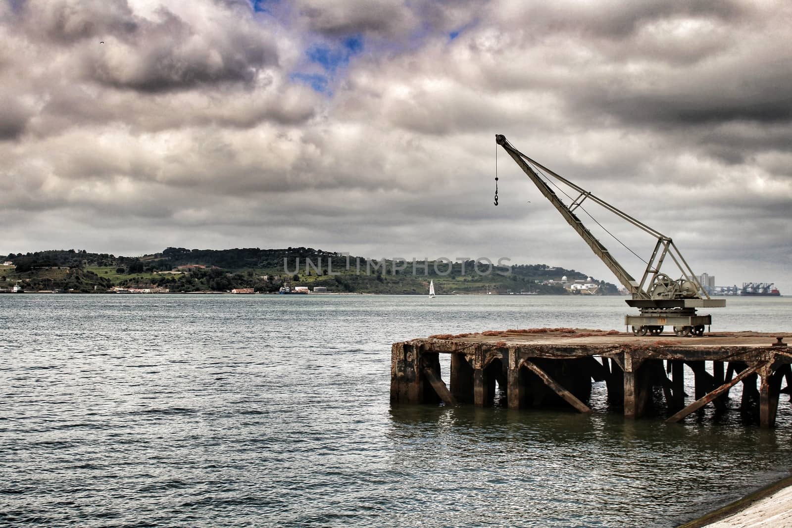 Old crane and dock on the shore of The Tagus River