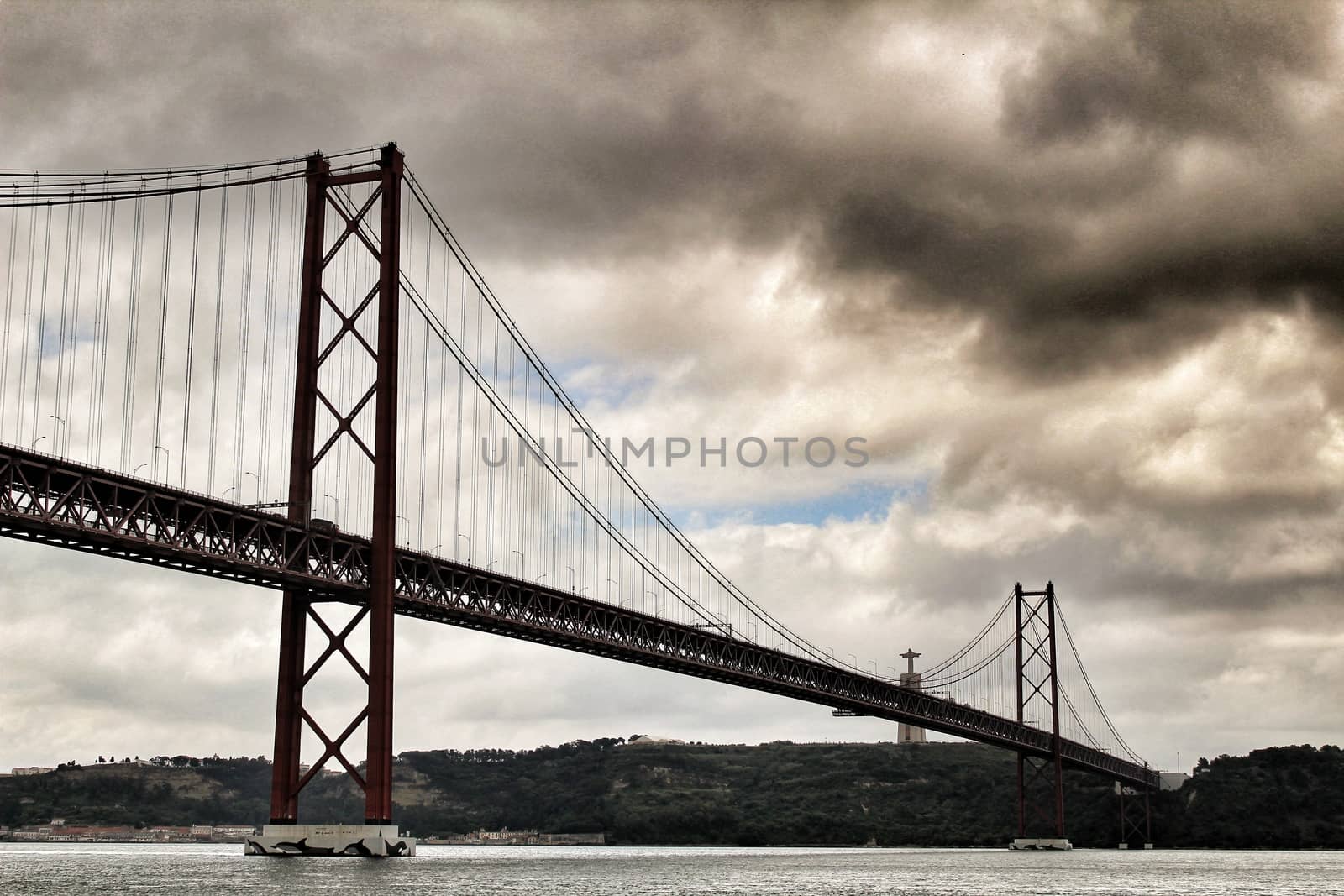 25th April Bridge in Lisbon on a cloudy day by soniabonet