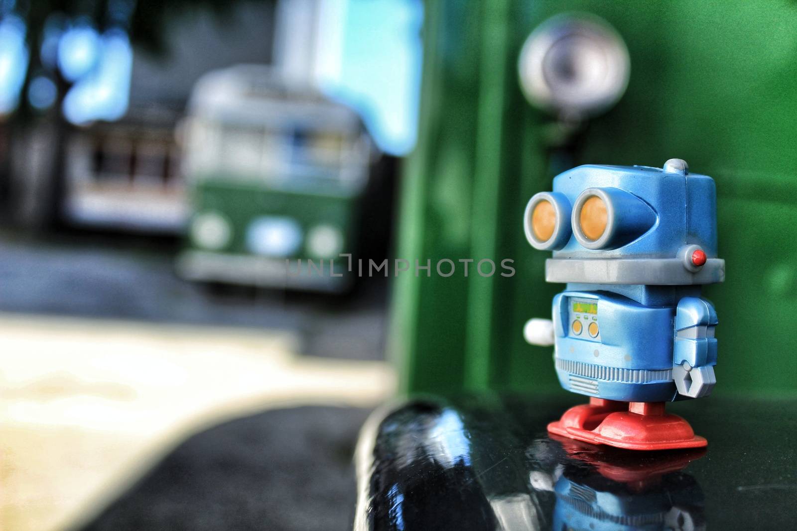 Toy robot on old bus school by soniabonet
