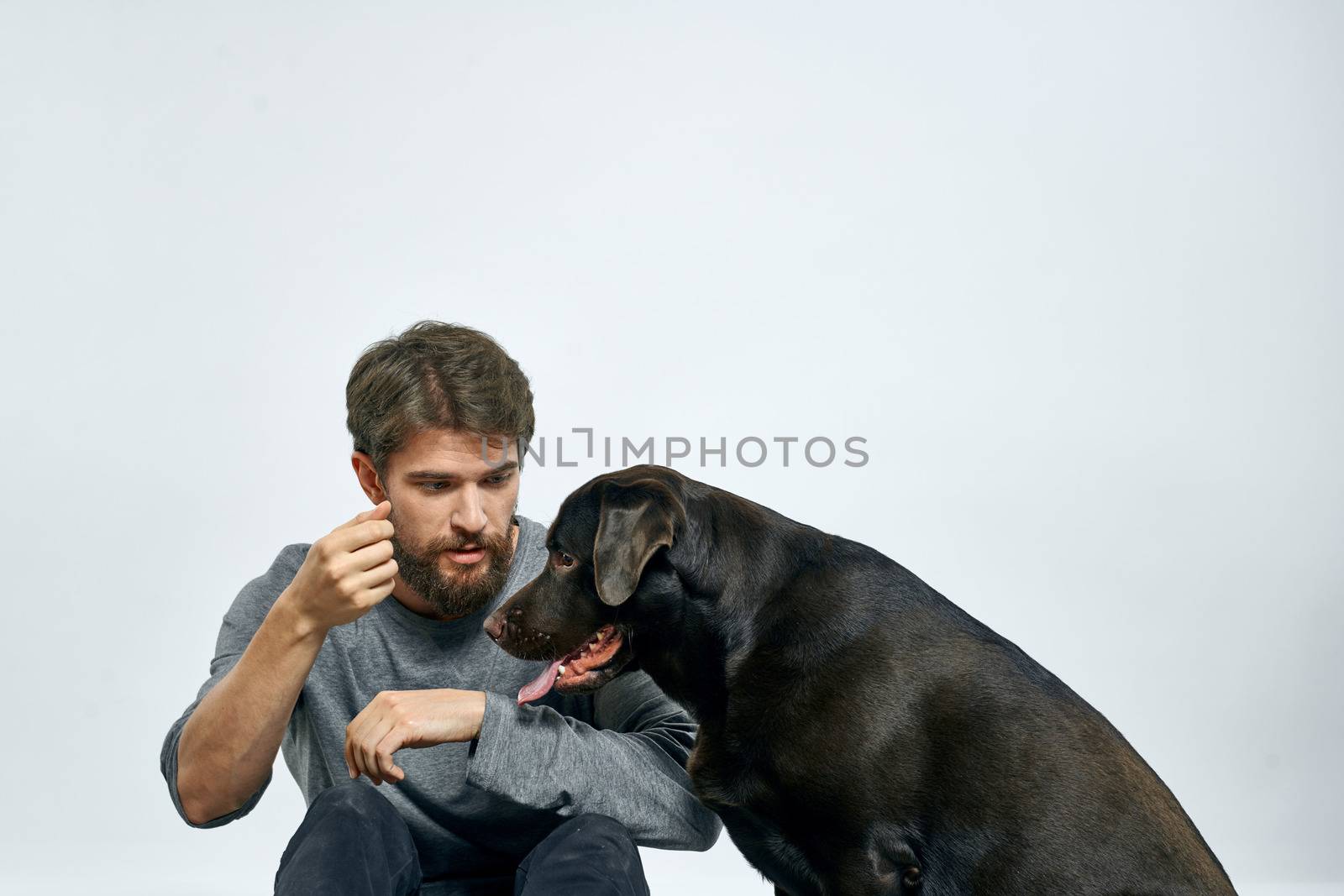 happy owner with pet black dog training model emotions by SHOTPRIME