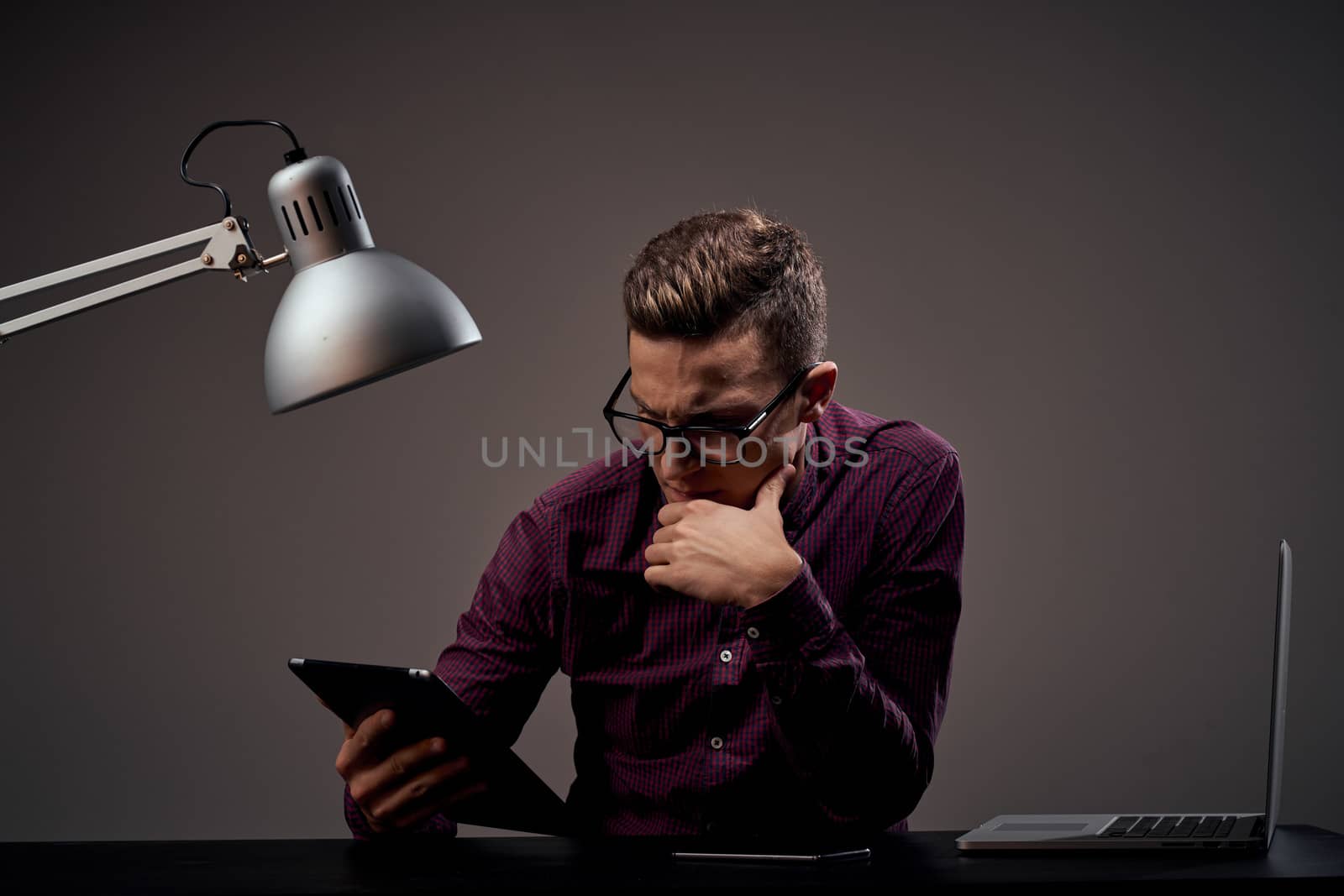 Male manager in the office puzzled look lamp cabinet workplace by SHOTPRIME