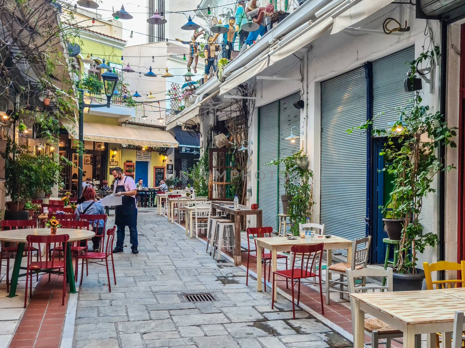 Less crowd eating & drinking at mostly empty tavernas in the center at Bezesteni area.